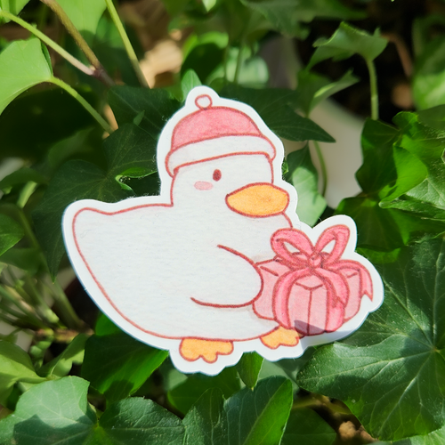 Duck sticker with a cute christmas hat on and a christmas gift in his hands