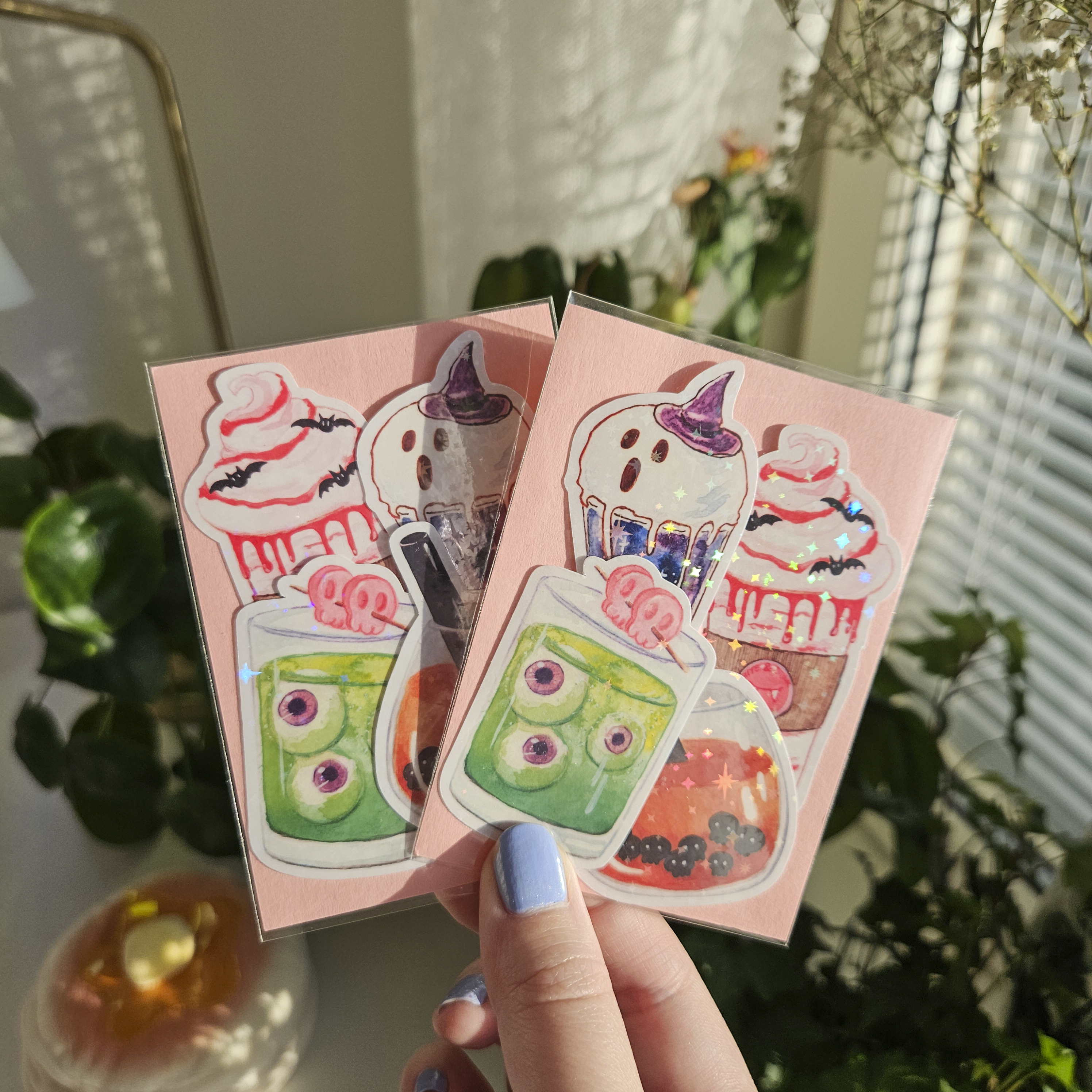 Two pink sticker packs with 4 stickers inside. Halloween themed drinks.