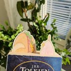 Baguette and strawberry bookmarks used inside a book. Top of bookmark sticking out.