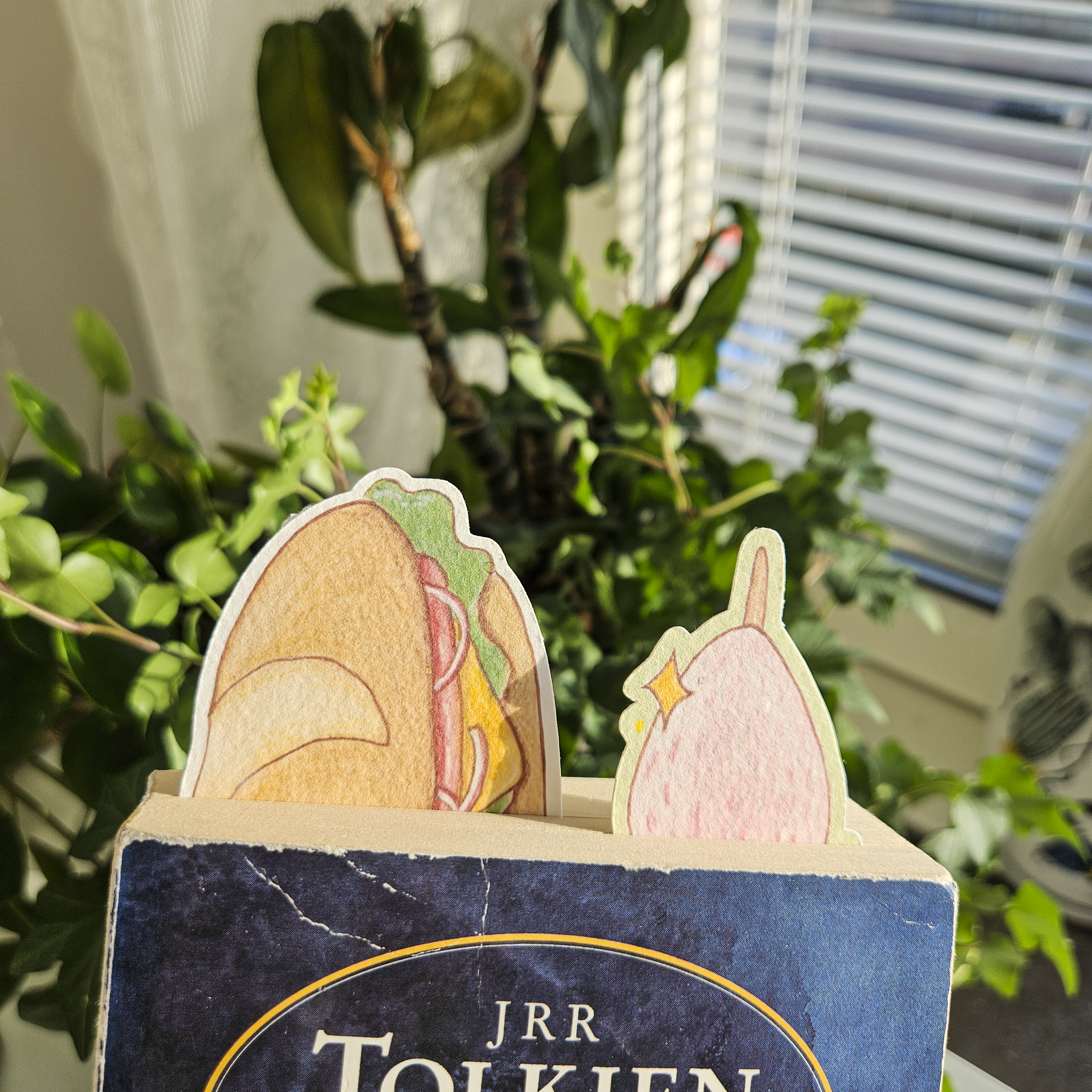 Baguette and strawberry bookmarks used inside a book. Top of bookmark sticking out.